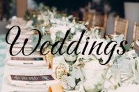 a table set up for a wedding with the words weddings written on it